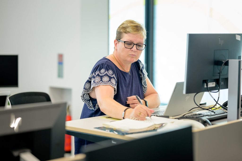 Female accountant writing down on her notebook