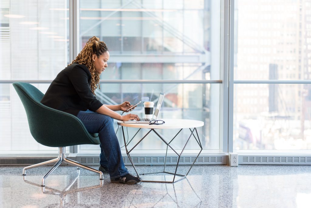 accounants working with his laptop white sitting on a chair