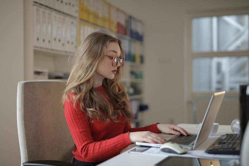 accountant with glasses working with her laptop