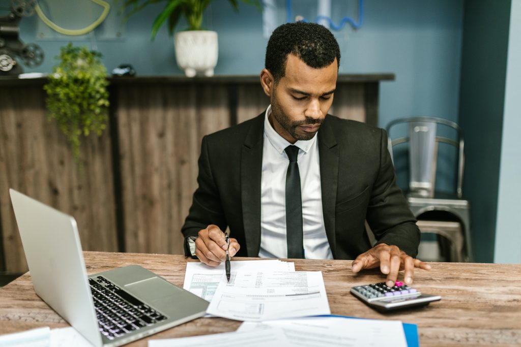 accountant using his calculator to check the tax