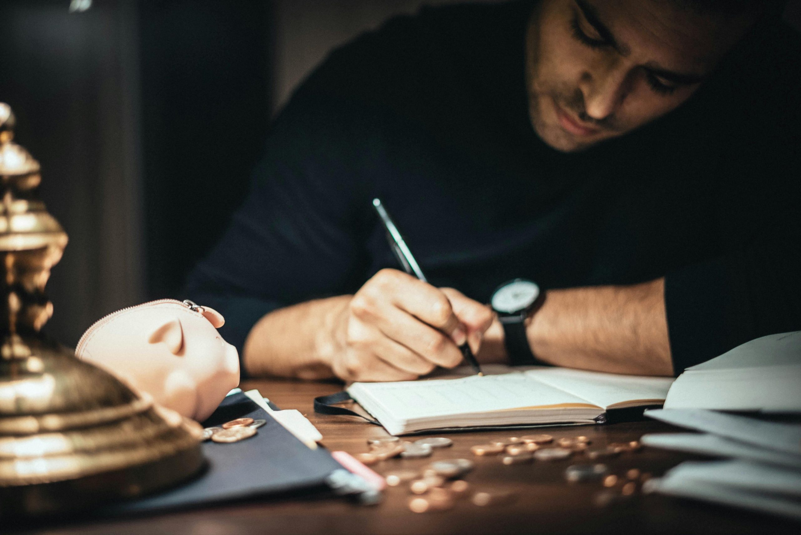 accountant writing details on his notebook