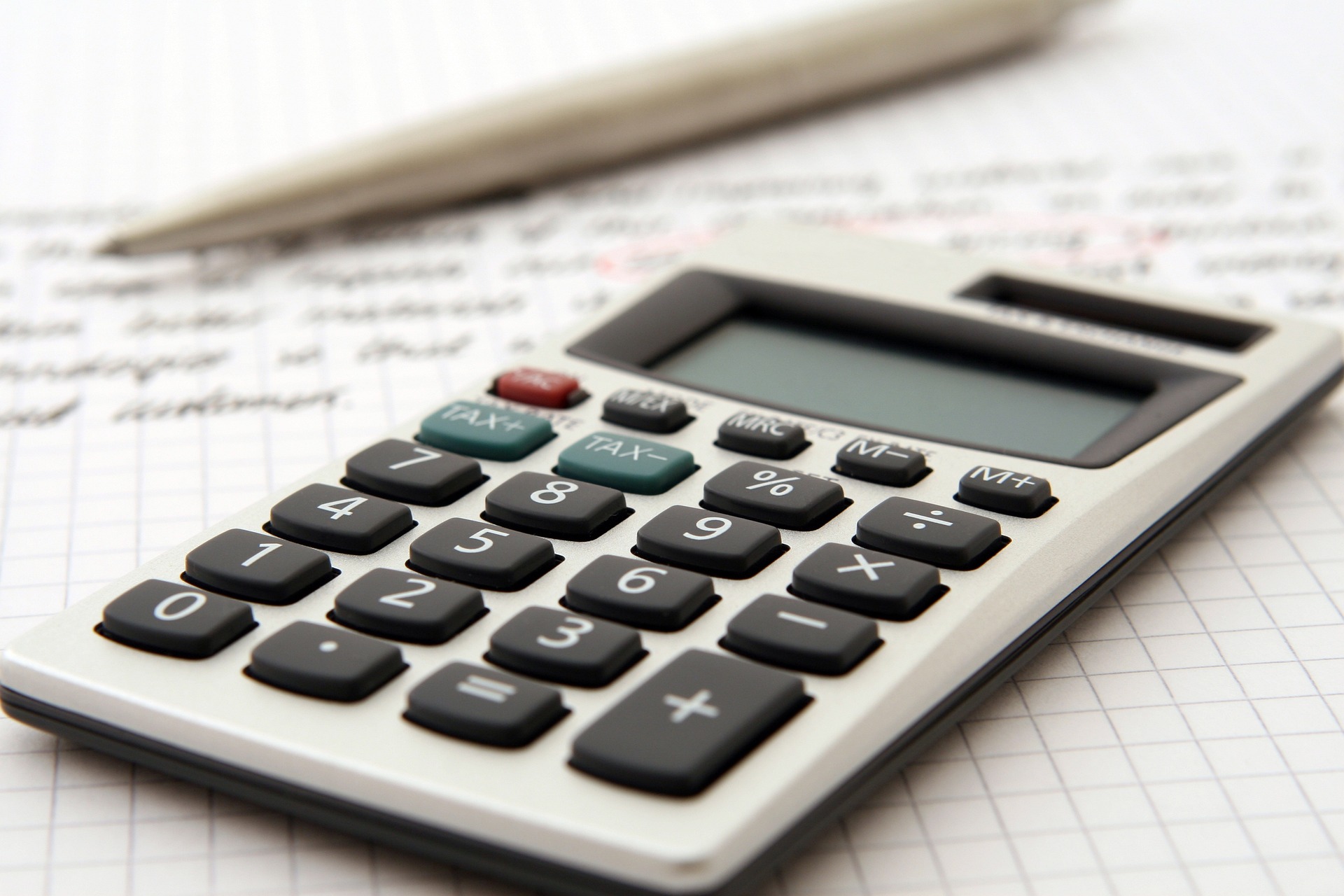 white calculator on top of a paper