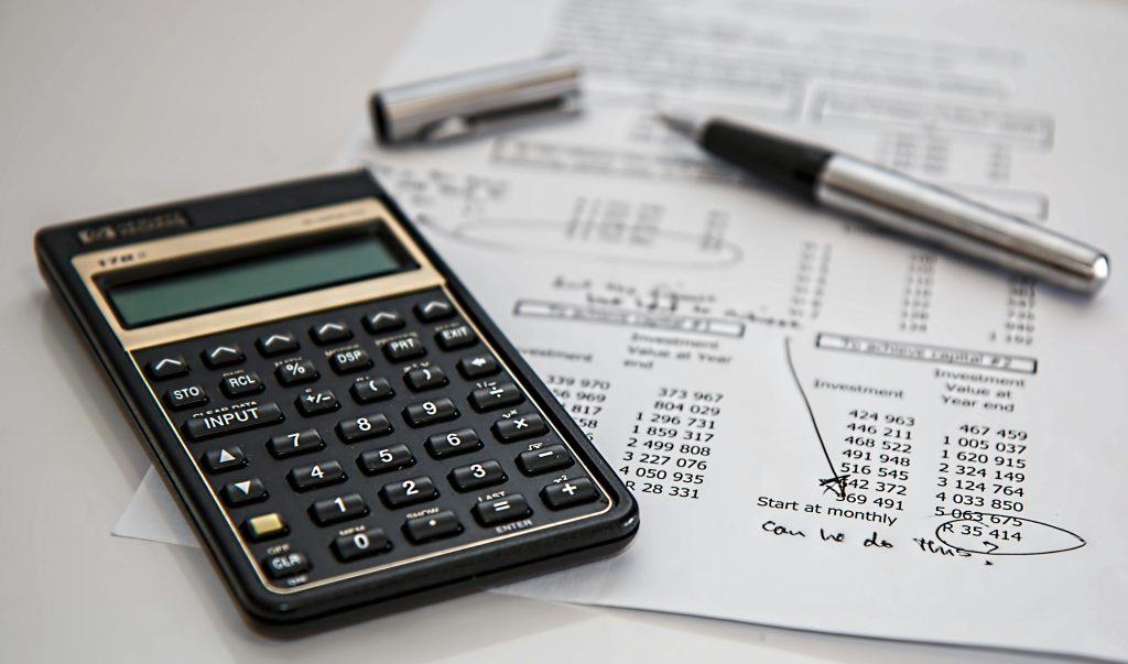 calculator and pen above a tax receipt