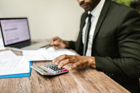 accountant computing tax returns using a calculator